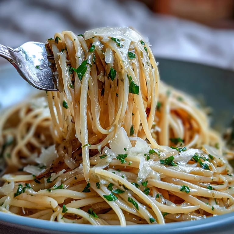 A quick, savory garlic butter pasta with melted Parmesan cheese.