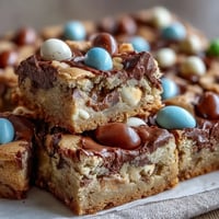 Peanut Butter Easter Egg Cookie Bars with colorful candies and rich chocolate chips, baked to golden perfection in a soft, chewy dessert.