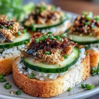 Golden Crispy Rice Sardine Toasts appetizer, showcasing crunchy texture and fresh garnishes.